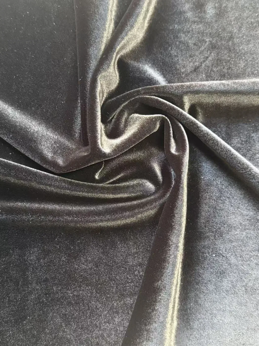 MJ 7124 short-pile bright stretch velvet in black, showing fluid drape and sheen